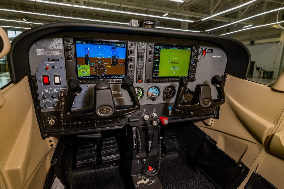 Glass cockpit of an LLFA training aircraft showing the primary and multi-function displays