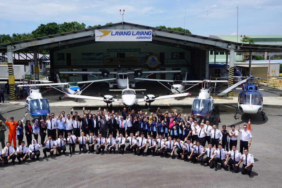 Layang Layang Flying Academy team in front of the aeroplane and helicopter fleet