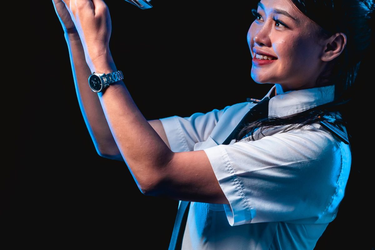 Layang Layang Flying Academy cadet holding a model of a training aircraft